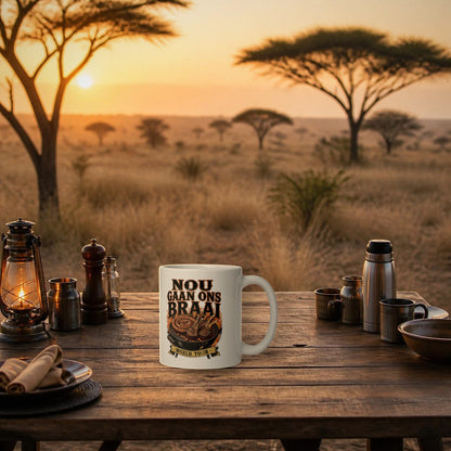 Nou Gaan Ons Braai Mug – white mug with 'World Tour' braai print on a bushveld camp table at sunrise